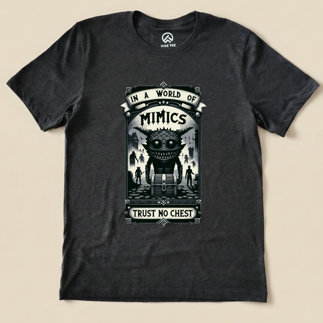 The graphic t-shirt features a bold design with the words "In a World of Mimics" and "Trust No Chest" above an illustrated creature.