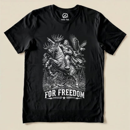 A graphic t-shirt featuring a moose, Bigfoot, and an eagle with the slogan "FOR FREEDOM" beneath them, titled "Moose Bigfoot Resist Shirt".