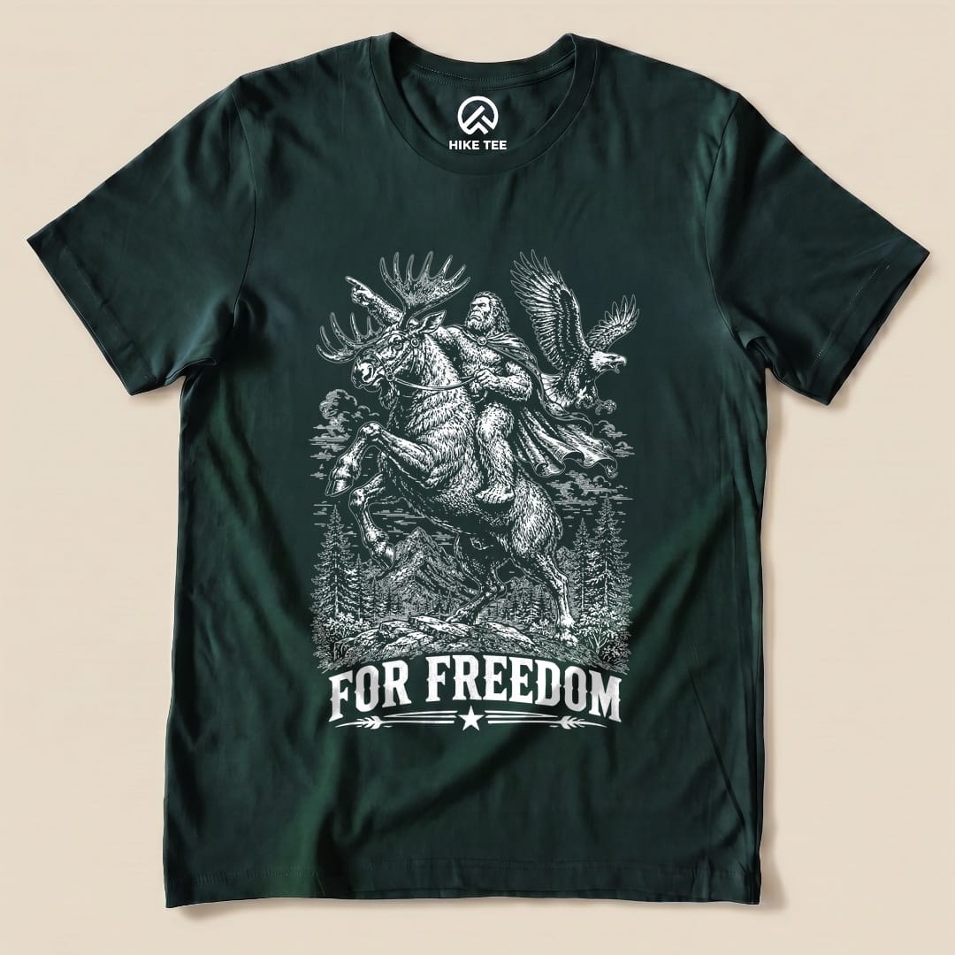 Graphic t-shirt featuring a moose, Bigfoot, and an eagle, with the slogan "FOR FREEDOM," highlighting the Moose Bigfoot Resist Shirt design.