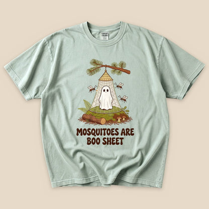 A mint green graphic t-shirt featuring a comical design of a ghost trapped in a mosquito net with the text "Mosquitoes Are Boo Sheet.