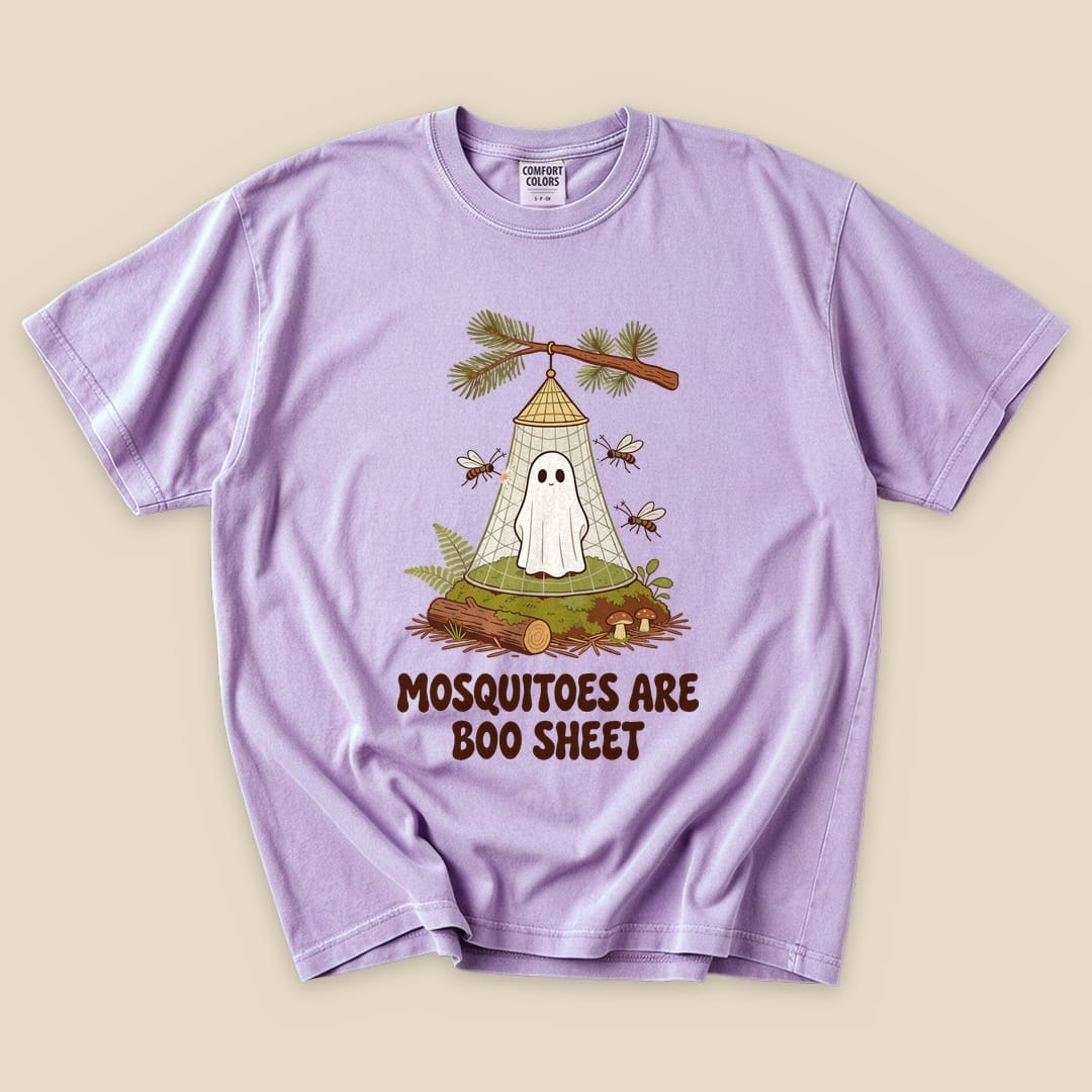 A lavender graphic t-shirt features a playful design of a ghost trapped in a mosquito net with the phrase "Mosquitoes Are Boo Sheet.
