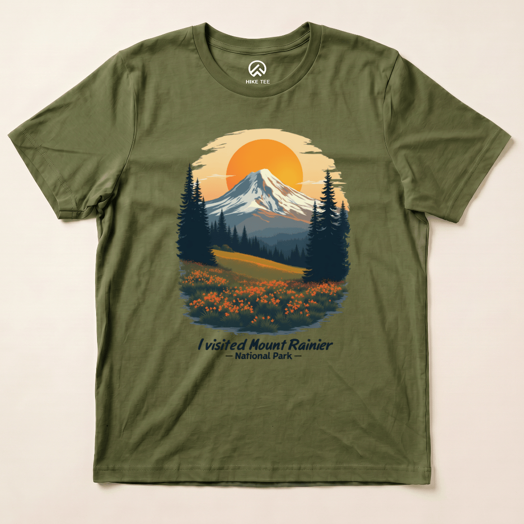 A graphic t-shirt featuring an illustrated design of Mount Rainier with the text "I visited Mount Rainier National Park" in a scenic setting.