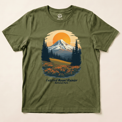 A graphic t-shirt featuring an illustrated design of Mount Rainier with the text "I visited Mount Rainier National Park" in a scenic setting.