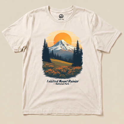 A graphic t-shirt featuring a scenic illustration of Mount Rainier with the text "I visited Mount Rainier National Park" below.