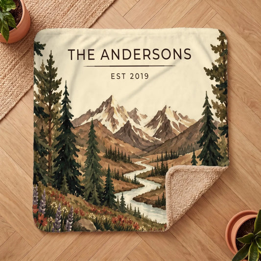 Personalized Mountain River Wildflower Sherpa Blanket on a wooden floor with the cozy sherpa back showing