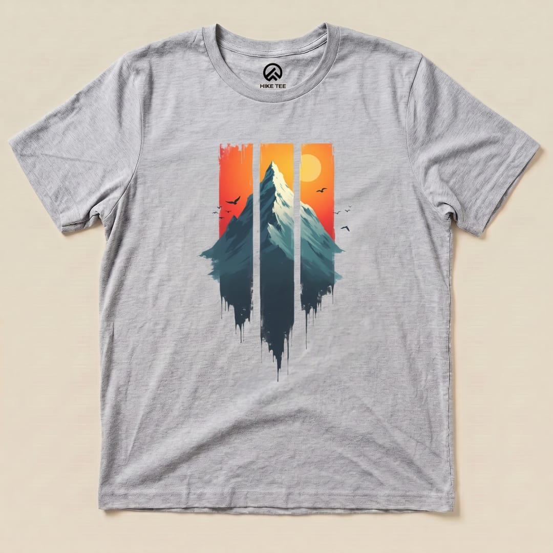 Graphic t-shirt featuring a mountain landscape with a sunset in vibrant colors, titled "Mountain Sunset Shirt.