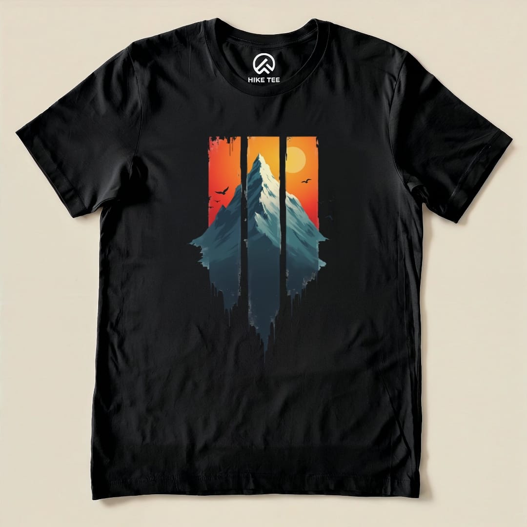 A black graphic t-shirt featuring the "Mountain Sunset Shirt" design with a mountain silhouette against a sunset background.
