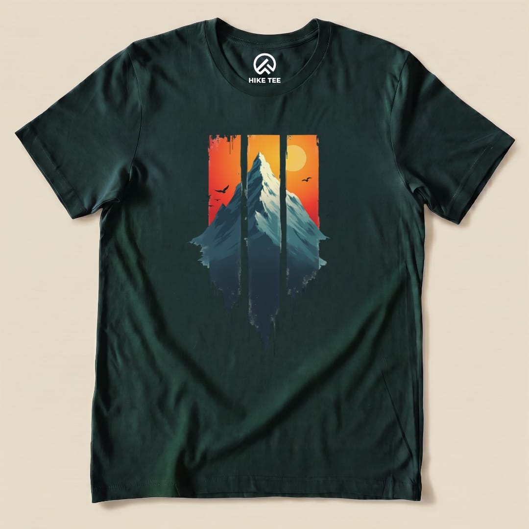 A graphic t-shirt features a mountain design with a vibrant sunset background in shades of orange and red, titled "Mountain Sunset Shirt".