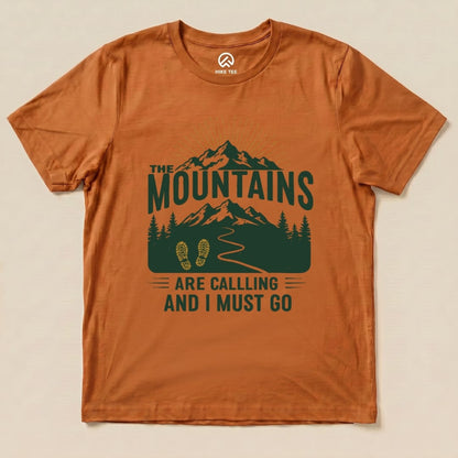 The Mountains Are Calling Shirt features a graphic design of mountains, trees, and a hiking path with the slogan "ARE CALLING AND I MUST GO".