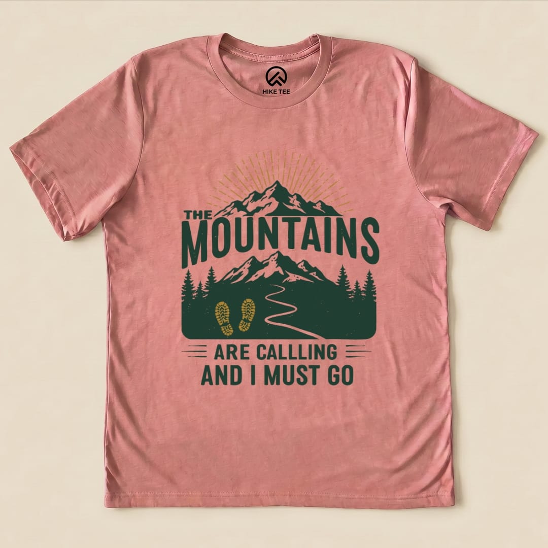 A pink graphic t-shirt features the slogan "THE MOUNTAINS ARE CALLING AND I MUST GO" with mountain and trail designs.