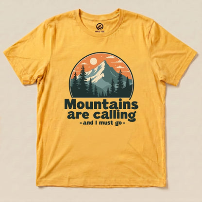 A yellow graphic t-shirt features the slogan "Mountains are calling - and I must go" with a mountain and forest design.