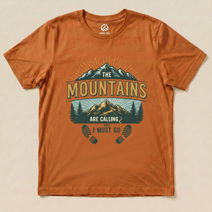 The graphic t-shirt features the phrase "The Mountains are Calling and I Must Go" above a scenic mountain and forest design.