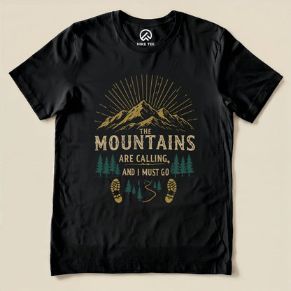 The graphic t-shirt features a mountain scene with the phrase "THE MOUNTAINS ARE CALLING, AND I MUST GO" in a vibrant design.