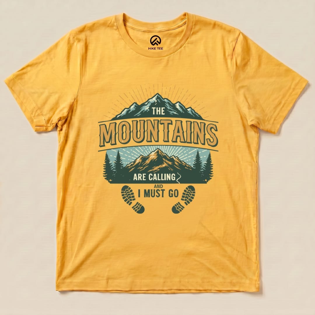 A vibrant yellow graphic t-shirt features the slogan "The Mountains are Calling and I Must Go" along with mountain and tree illustrations.