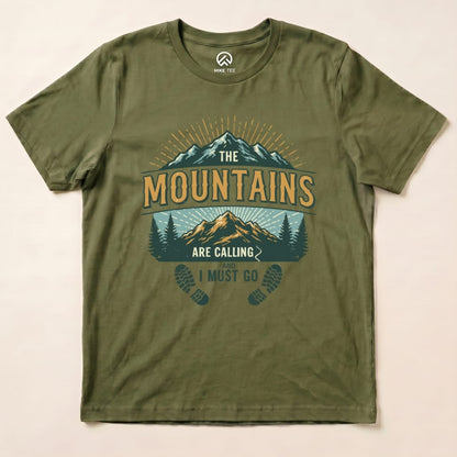 The olive green graphic t-shirt features a mountain design and the phrase "The Mountains Are Calling and I Must Go.
