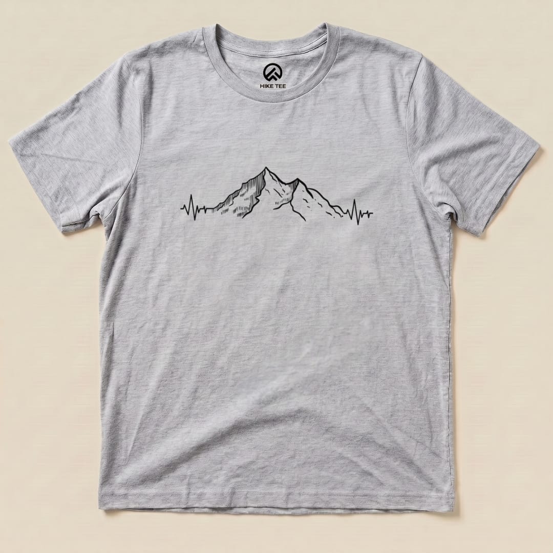 A graphic t-shirt featuring a mountain design with a heartbeat line, labeled as the "Mountains Heart Rate Shirt.