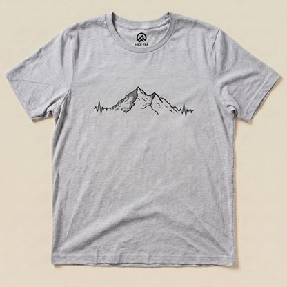 A graphic t-shirt featuring a mountain design with a heartbeat line, labeled as the "Mountains Heart Rate Shirt.