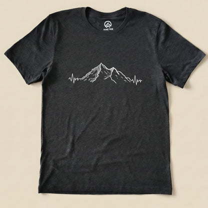 A graphic t-shirt featuring a mountain design with a heartbeat line, representing the "Mountains Heart Rate Shirt.
