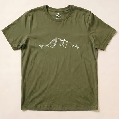 A graphic t-shirt in olive green featuring a mountain design with a heartbeat line underneath, labeled "Mountains Heart Rate Shirt".