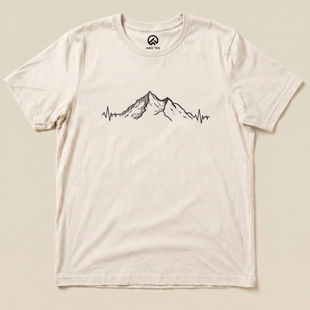 A graphic t-shirt featuring a mountain silhouette with an electrocardiogram line, labeled as the "Mountains Heart Rate Shirt".