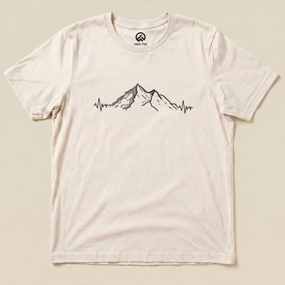 A graphic t-shirt featuring a mountain silhouette with an electrocardiogram line, labeled as the "Mountains Heart Rate Shirt".