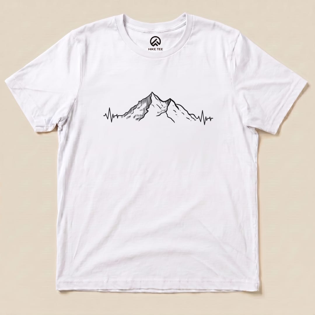 A white graphic t-shirt featuring a mountain range design integrated with a heartbeat line, labeled as the "Mountains Heart Rate Shirt.