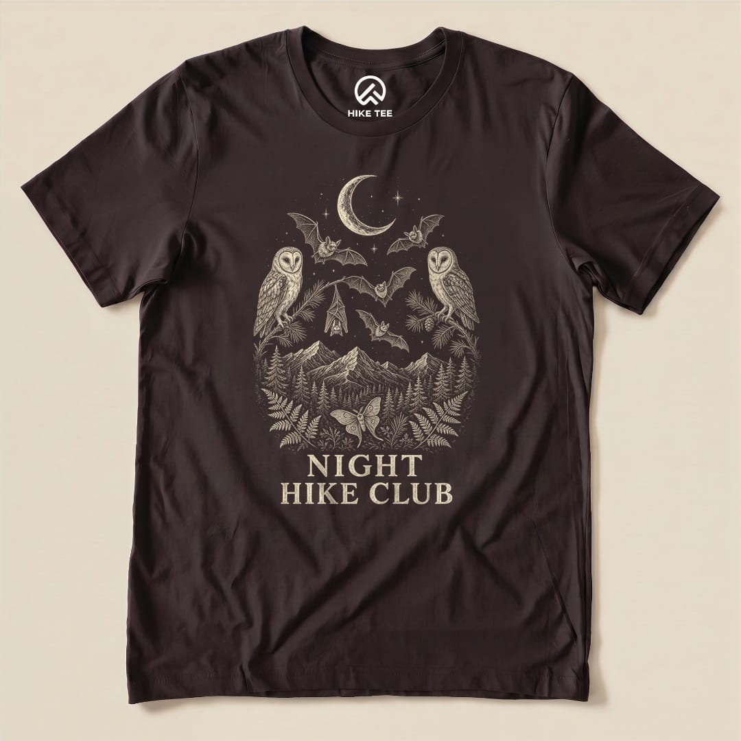 A dark graphic t-shirt features an artistic design of owls, bats, and mountains with the text "NIGHT HIKE CLUB" prominently displayed.