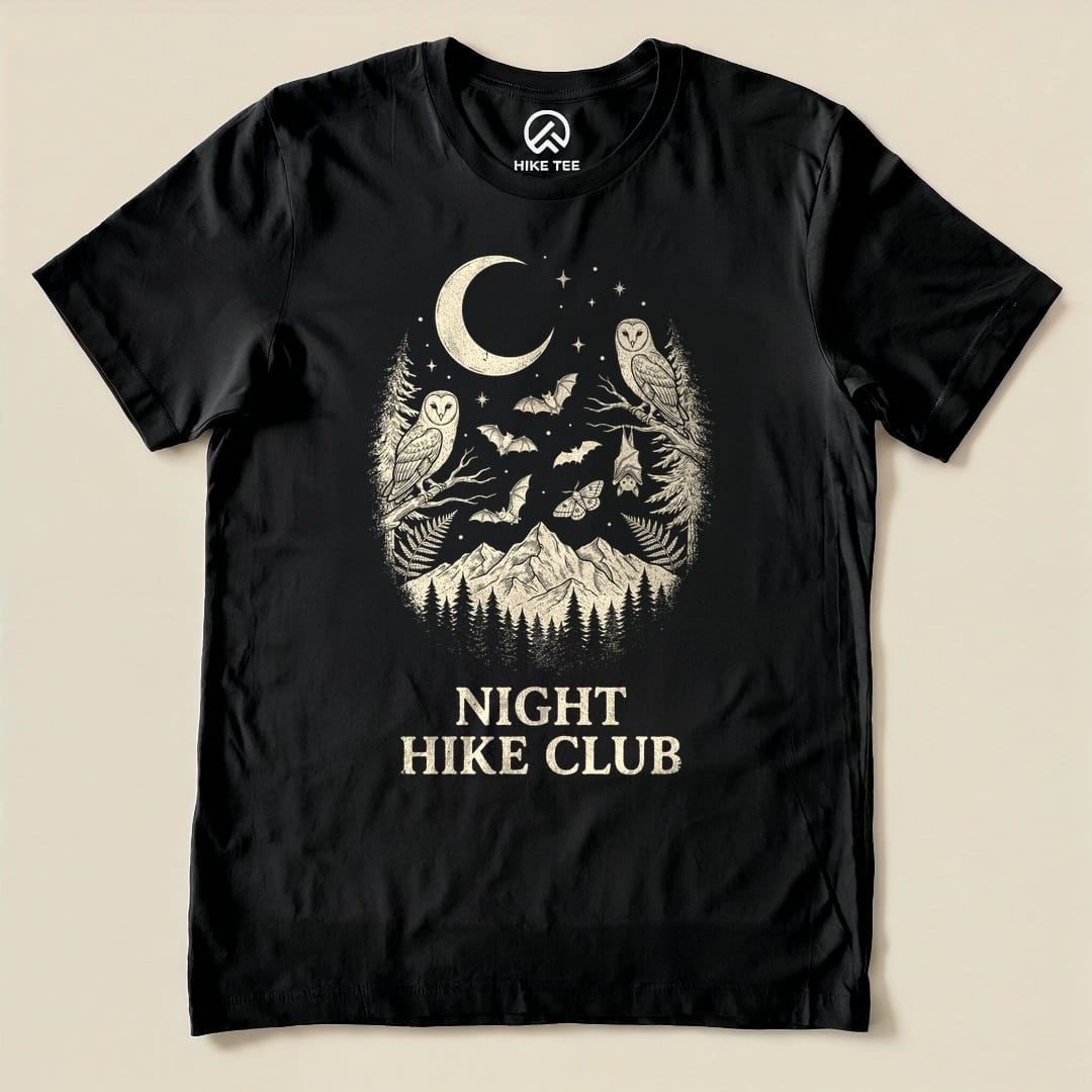 The black graphic t-shirt features an intricate design with owls, bats, and mountains, showcasing the "Night Hike Club Shirt" slogan.