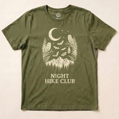 The olive green graphic t-shirt features a design with owls, bats, a crescent moon, and the text "NIGHT HIKE CLUB" below.