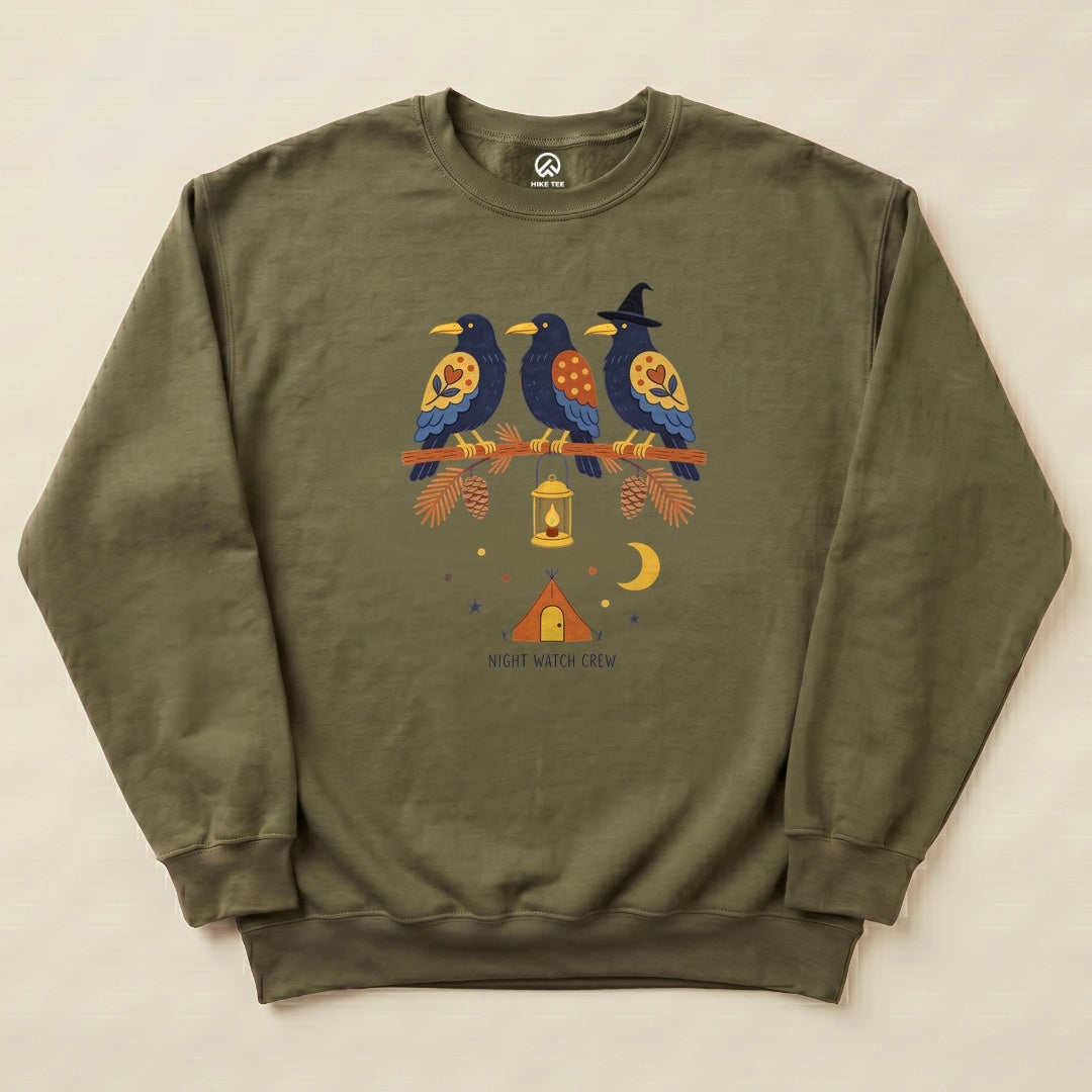 Military Green Night Watch Crew Sweatshirt with a folk-art crow trio on a pine branch with a lantern above a tent graphic