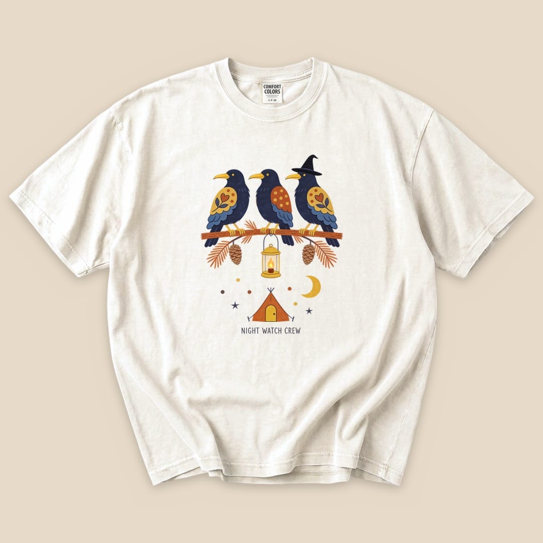 Graphic t-shirt featuring three colorful birds on a branch, a lantern, and "NIGHT WATCH CREW" printed underneath.