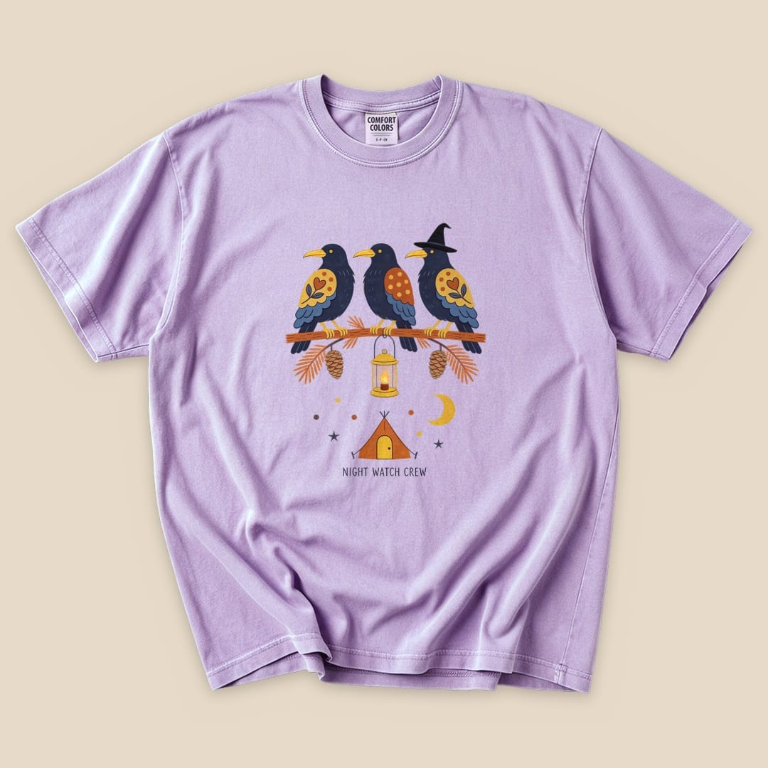 The lavender graphic t-shirt features three stylized birds perched on a branch, with a lantern and a crescent moon, labeled "NIGHT WATCH CREW.