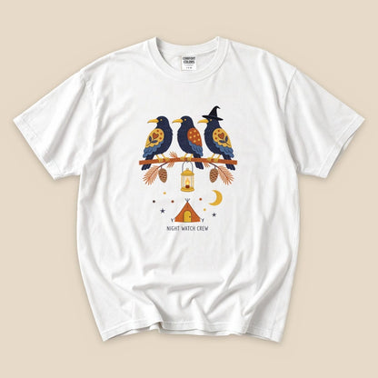The "Night Watch Crew T-Shirt" features three colorful birds perched on a branch, with a lantern and camping scene below.