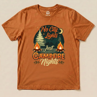 A graphic t-shirt in burnt orange featuring the slogan "No City Lights Just Campfire Nights" with campfire and tree illustrations.
