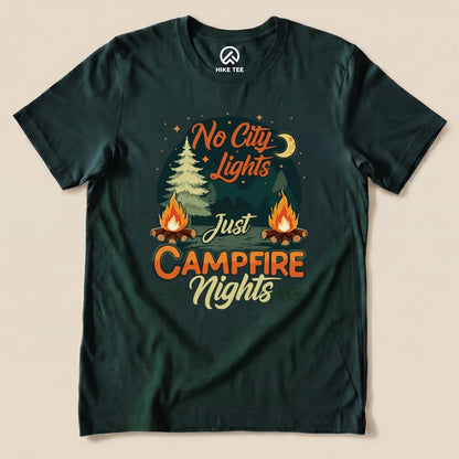 A dark green graphic t-shirt featuring the slogan "No City Lights Just Campfire Nights" with campfire and forest imagery.