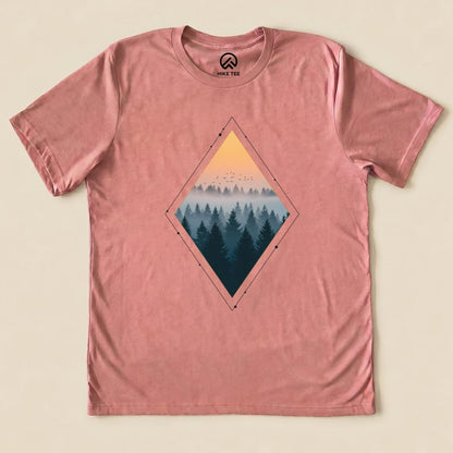 Nostalgic Forest Shirt featuring a diamond graphic with a serene forest silhouette and sunset tones on a pink background.