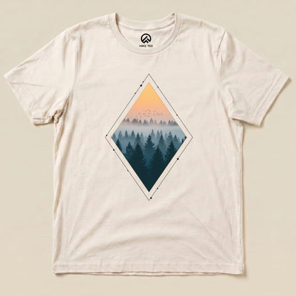 A flat lay of the graphic t-shirt features a "Nostalgic Forest Shirt" with a diamond graphic showing a misty forest at sunset.