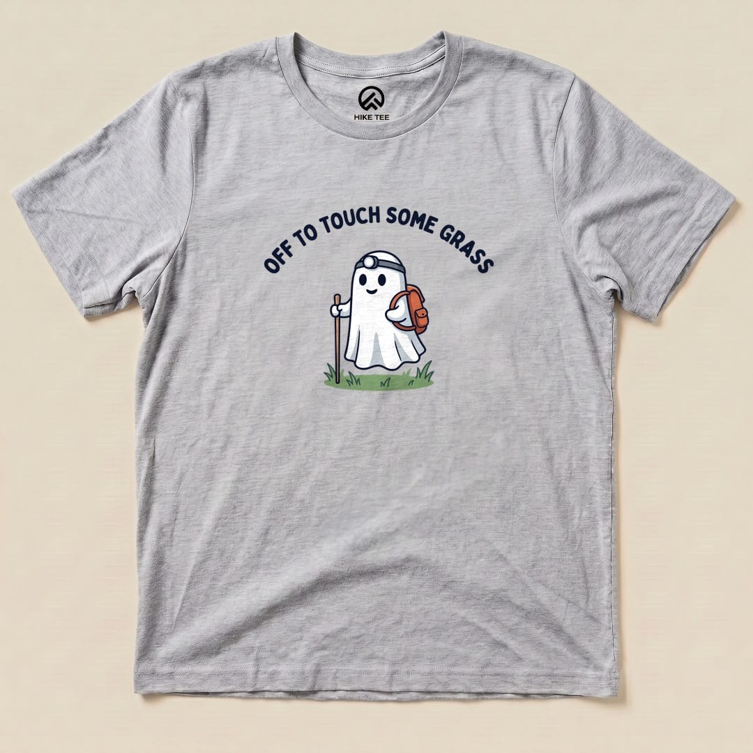 Athletic Heather Off to Touch Some Grass Shirt with a ghost hiker with a headlamp and backpack graphic