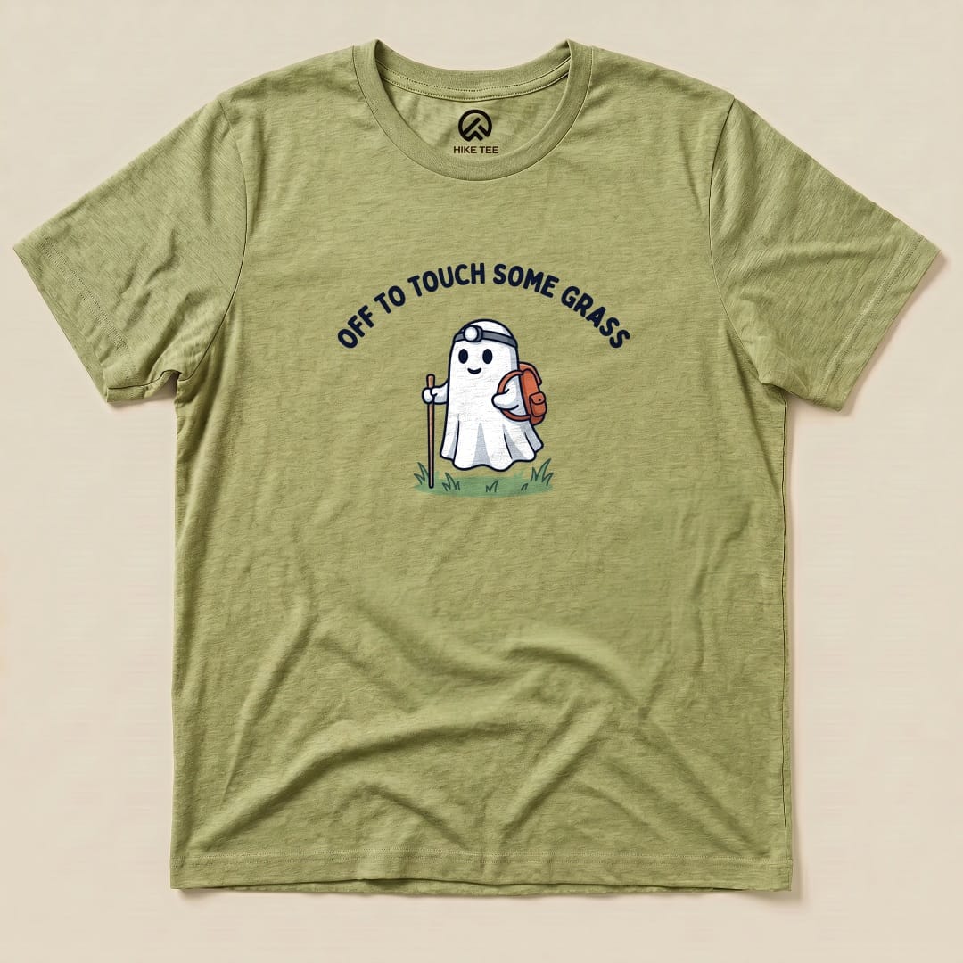 Heather Green Off to Touch Some Grass Shirt with a ghost hiker with a headlamp and backpack graphic
