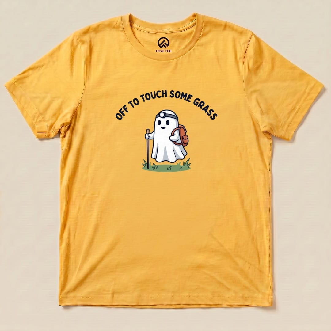 Gold Off to Touch Some Grass Shirt with a ghost hiker with a headlamp and backpack graphic