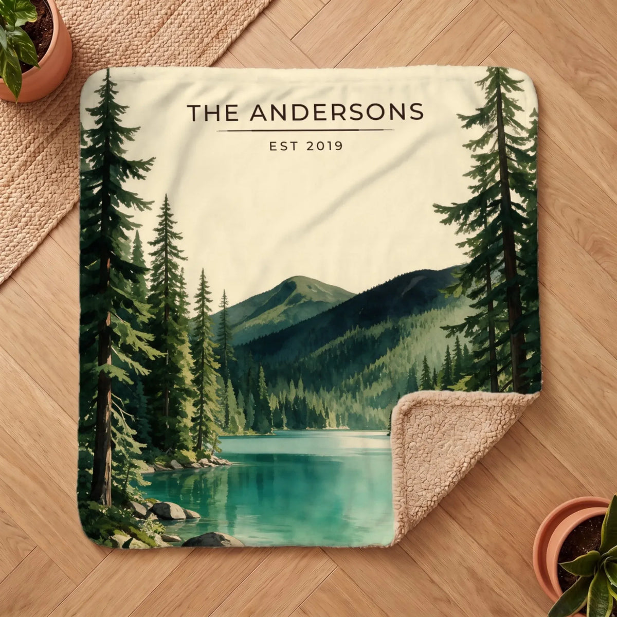 Personalized Olympic Lake Crescent Sherpa Blanket on a wooden floor with the cozy sherpa back showing