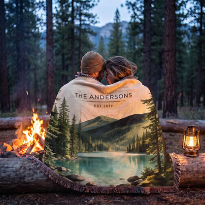 Couple wrapped in the Olympic Lake Crescent Woven Blanket by a campfire