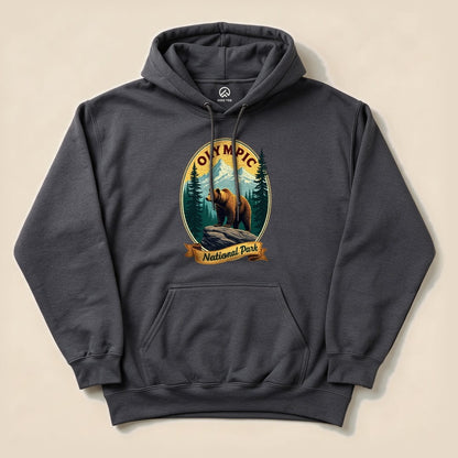 A graphic t-shirt featuring a bear standing on a rock with "Olympic National Park" and trees in the background.
