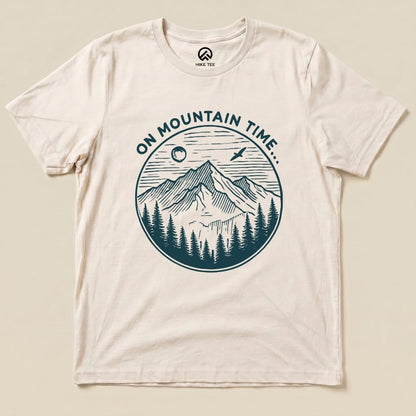 The On Mountain Time Shirt features a vintage-style graphic of mountains and trees with the phrase "ON MOUNTAIN TIME..." printed above.