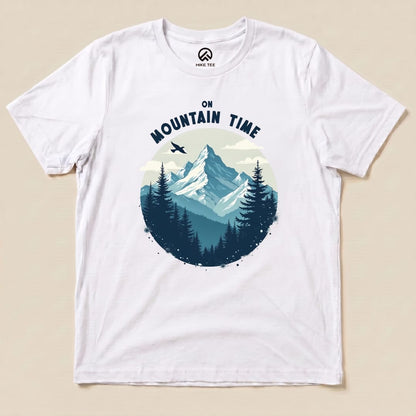 The On Mountain Time Shirt features a scenic graphic of mountains and pine trees, set within a circular design on a white tee.