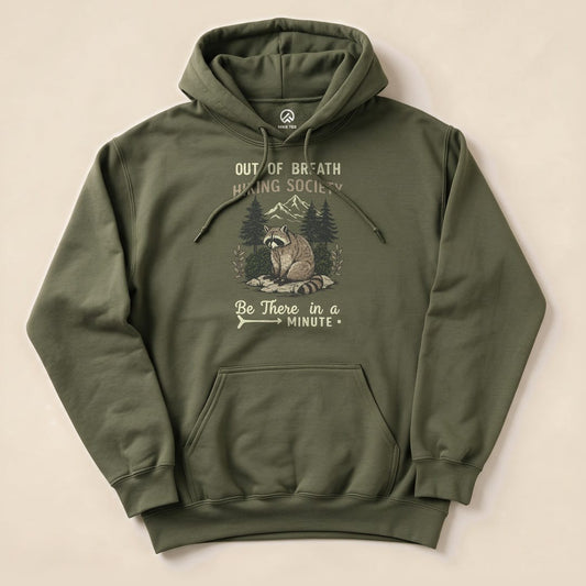 Olive green hoodie featuring a raccoon graphic with the text "Out of Breath Hiking Society" and "Be There in a Minute.