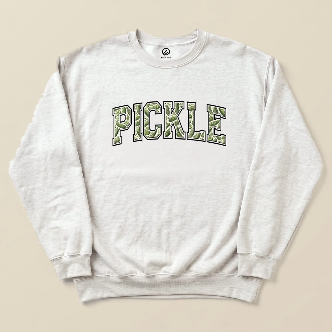 A light gray sweatshirt features the word "PICKLE" in a bold, green graphic style, showcasing the Pickle Camping Sweatshirt design.