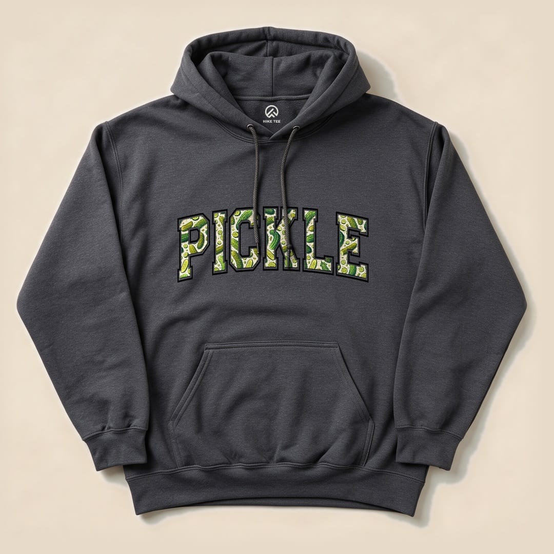 A dark gray Pickle Hoodie featuring bold, green graphic text spelling "PICKLE" with pickle illustrations inside the letters.