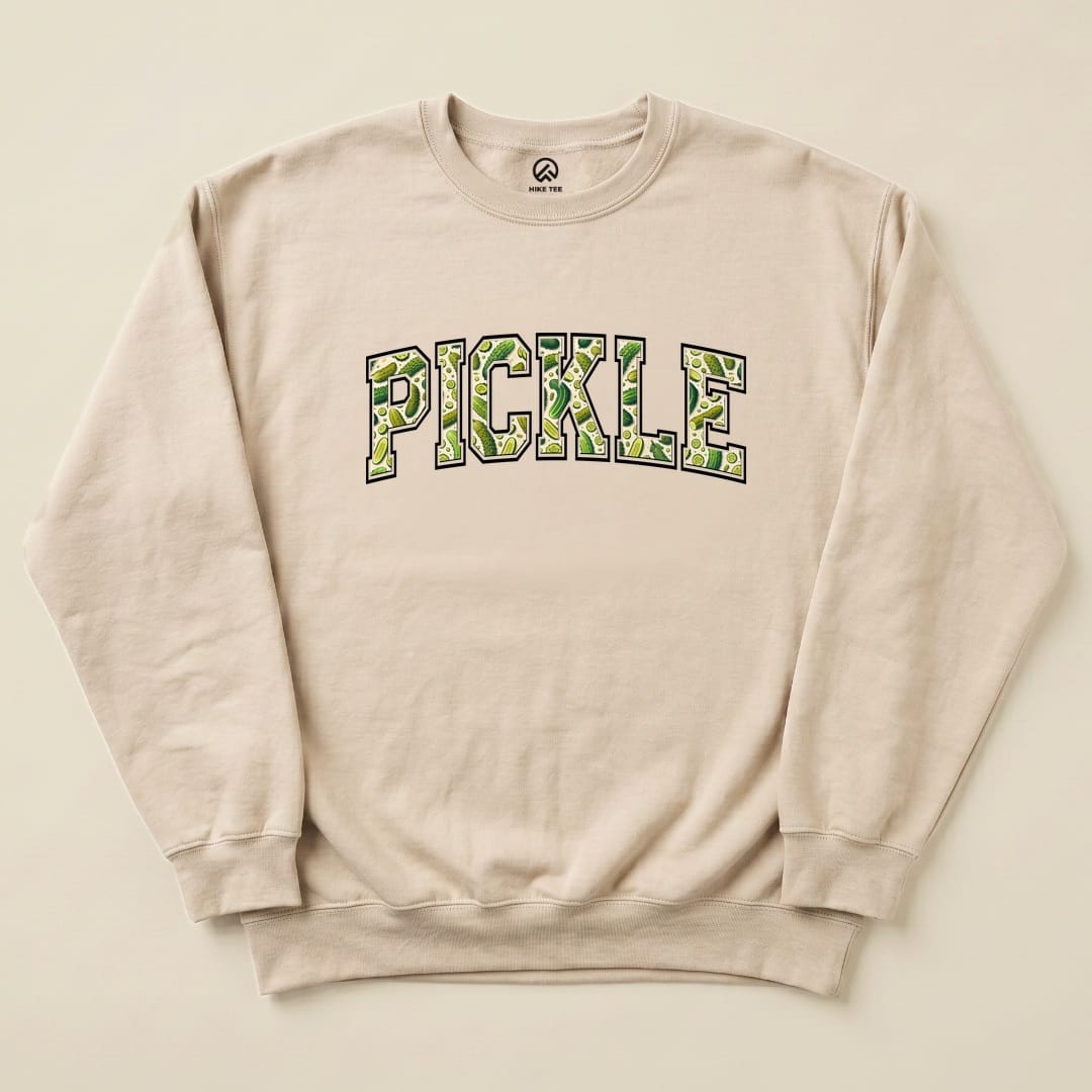 A beige "Pickle Sweatshirt" featuring the word "PICKLE" in a playful green design, laid flat against a light background.