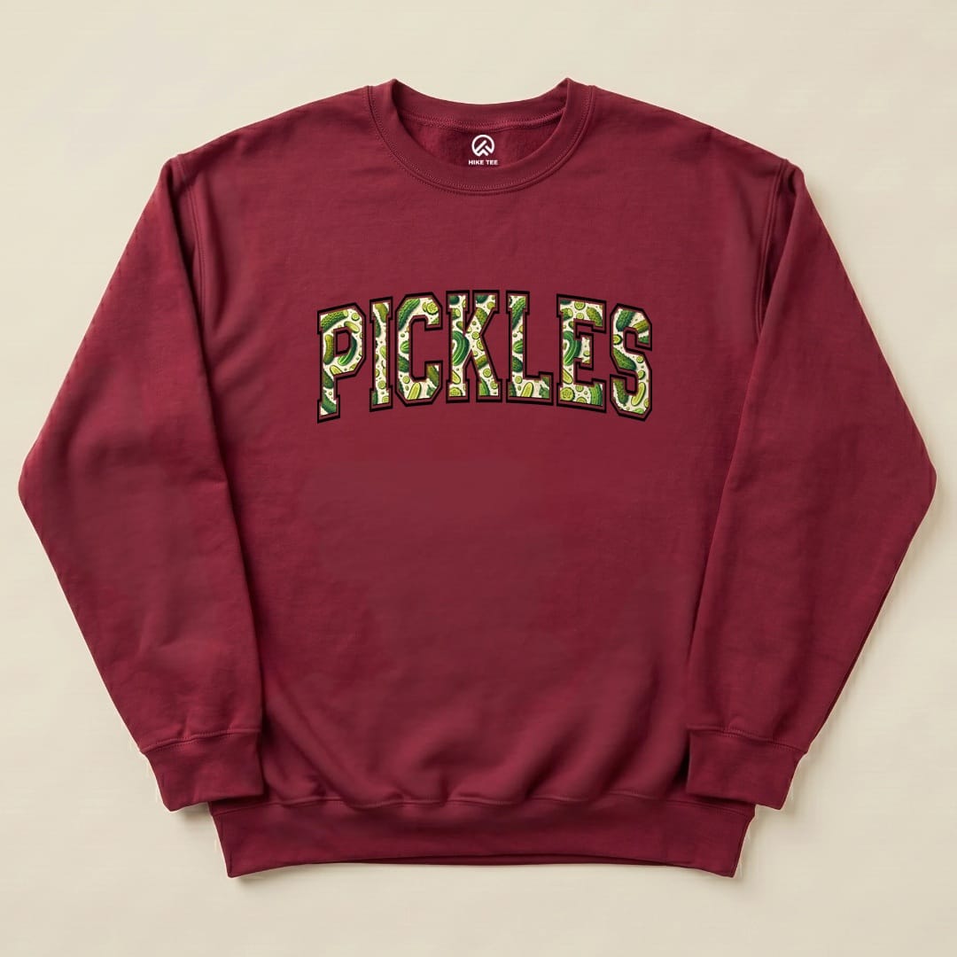 A maroon "Pickles Sweatshirt" features bold, colorful lettering of the word "PICKLES" with a playful design, making it a fun graphic sweatshirt.